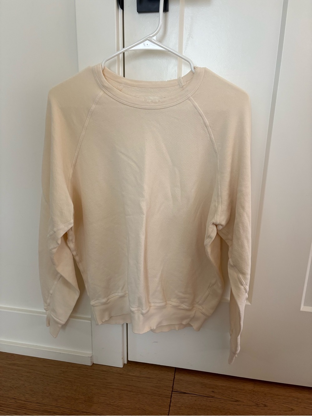THE GREAT. Soft Cream Crewneck Sweatshirt with Distressed Details
